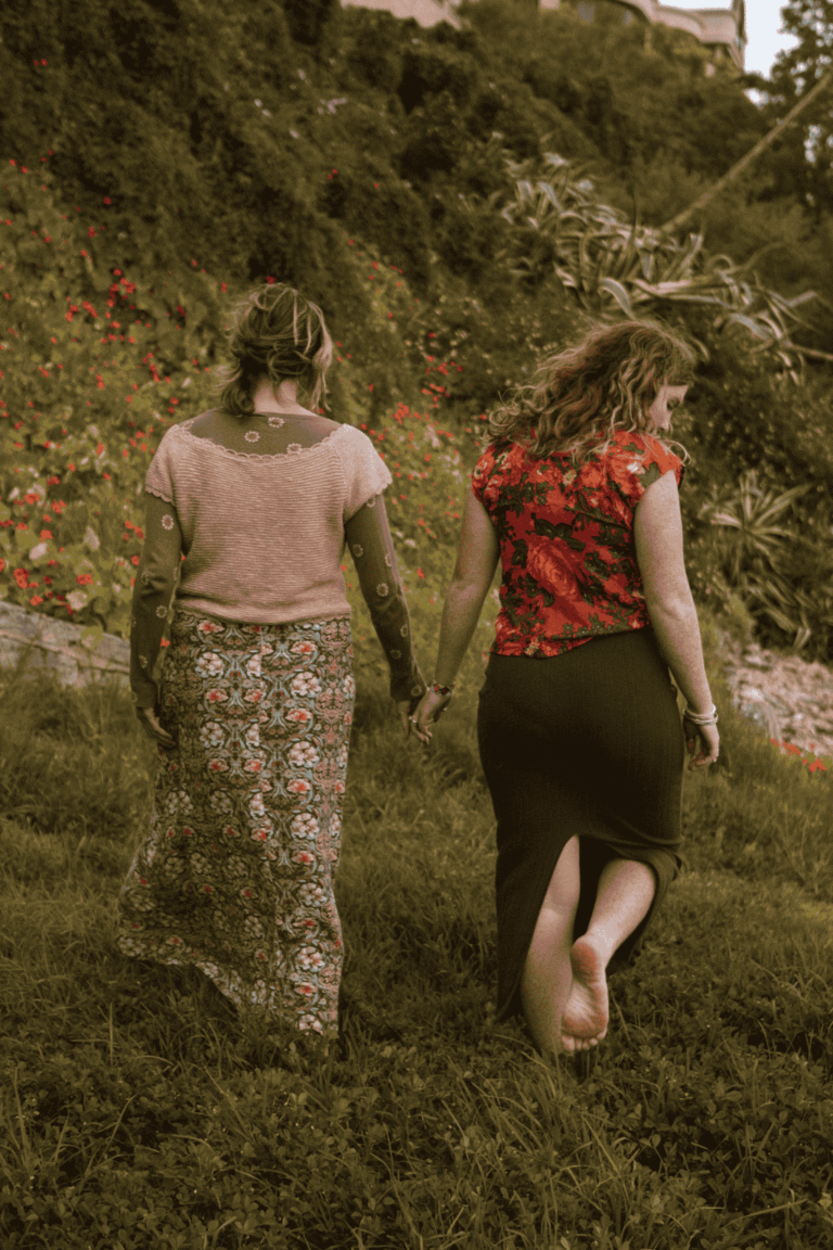 mother in 50's and daughter 17, walking away from the camera on a greased hilly area